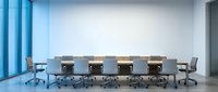 Modern conference room with long wooden table and ergonomic chairs against white wall with large blue windows for corporate meetings and business presentations.