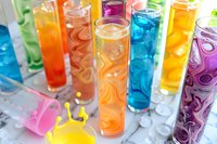 Colorful summer cocktails in tall glasses with ice cubes, vibrant drinks in pink, blue, orange, yellow and purple hues, refreshing beverages for party menu.