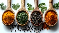 Wooden spoons filled with vibrant spices and herbs including turmeric powder, dried parsley, black peppercorns, and paprika powder arranged on white background.