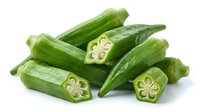 Fresh green okra pods with cross-sections showing star-shaped interior, isolated on white background for culinary and healthy eating designs.