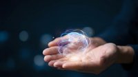 Glowing brain hologram floating above open palm against dark background with bokeh lights for technology and artificial intelligence concepts.