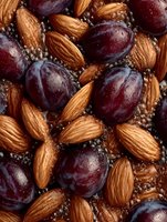 Fresh red grapes and roasted almonds with chia seeds in macro view, healthy food ingredients pattern for natural nutrition background.