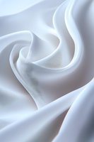 Soft white silk fabric with elegant folds and curves creating gentle waves and shadows, suitable for luxury fashion and wedding design backgrounds.