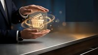 Shopping cart icon glowing with golden light between hands of businessman at desk, representing e-commerce, online retail, digital shopping, and business growth.