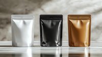 Metallic foil stand up pouches in white, black and gold colors arranged in row on marble surface, blank mockup for product packaging design.