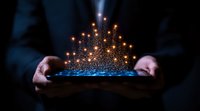 Glowing magical particles rising from digital tablet held in hands against dark background, creating ethereal light display for technology concept.