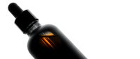 Dark amber glass dropper bottle with black cap isolated on white background for cosmetic serum oil tincture packaging design.