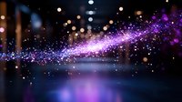 Magical glowing trail of purple and blue sparkles on dark background with bokeh lights and reflective surface creates dreamy atmospheric effect.