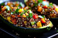 Stuffed zucchini boats filled with colorful quinoa, diced bell peppers, fresh herbs on black plate, close up view showing texture and vibrant ingredients.