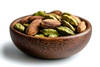 Whole cardamom pods and almonds in wooden bowl against white background, macro food photography showing texture and detail of aromatic spices and nuts.