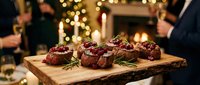 Gourmet beef steaks with cranberry sauce and rosemary on wooden board at elegant holiday dinner party with warm bokeh lights and festive atmosphere.