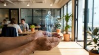 Young adult male with medium skin tone holding holographic human body projection in modern office environment, representing healthcare technology and digital innovation.