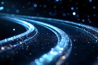 Glowing curved lines with sparkling particles create dynamic motion effect against dark background, blue light trails and bokeh for technology designs.