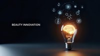 Glowing lightbulb with brain inside surrounded by beauty and skincare icons on dark background representing cosmetic innovation and creative ideas.
