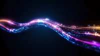 Glowing wave of digital particles with pink and blue light trails flowing through dark space, creating dynamic motion effect and futuristic energy stream.