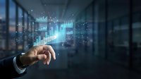 Businessman hand touching holographic financial charts and graphs displaying data analytics in modern office environment for business intelligence solutions.