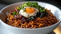 Korean instant ramen noodles with fried egg, green onions and seaweed in white bowl. Asian comfort food meal ready to eat.