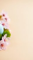 Easter composition with blue egg, pink cherry blossoms and green moss on beige background with copy space for spring holiday greeting cards.