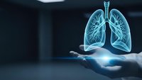 Glowing blue lungs hologram floating above open palm in dark medical environment for healthcare technology and respiratory system concepts.