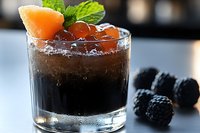 Refreshing cola cocktail with ice, grapefruit slice, and fresh mint garnish served in a rocks glass. Ideal for beverage menus, bar promotions, and drink recipe content.