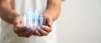 Hands holding glowing family figures representing protection, care and support services for insurance, healthcare and social welfare concepts.