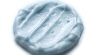 Soft blue whipped cream or frosting swirl with textured peaks and ridges, isolated on white background, suitable for bakery, dessert, and culinary design projects.