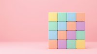 Colorful wooden toy blocks arranged in geometric pattern on pink background for children education and creative play activities.