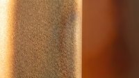 Warm golden sunlight casting soft shadows on textured beige wall surface creating abstract geometric patterns for interior design and architecture projects.
