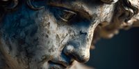 Ancient weathered stone Buddha statue face with serene expression showing meditation and spiritual enlightenment in warm golden light.