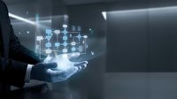 Businessman holding holographic network diagram with connected nodes and data flow visualization in modern office environment for digital transformation.