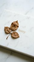 Dried autumn leaves on a marble surface with gold Sorry text, minimal apology concept for greeting cards and sympathy designs.
