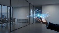 Businessman hand presenting holographic renewable energy technology with wind turbines and solar panels in modern office environment for sustainable business solutions.