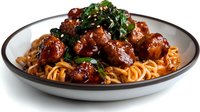 Delicious spaghetti pasta with savory meatballs in rich tomato sauce garnished with fresh herbs on white plate for restaurant menu and cooking content.