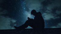 Young man silhouetted against starry night sky sitting alone while using mobile phone, dark moody atmosphere with clouds and stars in background.