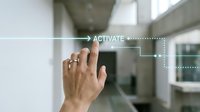 Caucasian male hand touching activate button on futuristic digital interface in modern office environment for technology, automation, and smart building control concepts.
