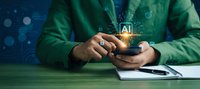 Businessman using smartphone with glowing AI artificial intelligence icon and digital network connections for modern technology and innovation concepts.
