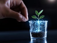 Young green plant growing in glass with glowing magical particles and soil, hand reaching towards sprout on dark background with copy space.