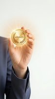 Close-up of a hand holding a glowing gold medal with loyalty emblem and laurel wreath design, symbolizing customer retention, brand loyalty, and business success.