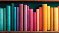Colorful books arranged in rainbow spectrum order on wooden shelf against dark green background, creating vibrant gradient display for education and library concepts.