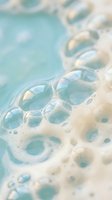 Abstract soap bubbles floating in turquoise water creating dreamy foam texture for spa wellness and relaxation concepts in soft pastel colors.