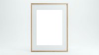 Empty wooden picture frame with white mat on light gray wall ready for artwork display and home decor projects.