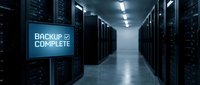 Modern data center server room with backup complete notification display showing successful data protection and storage management operations.