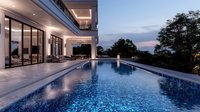 Modern luxury villa with illuminated infinity pool overlooking scenic sunset view, featuring glass walls, marble terrace and contemporary architectural design at dusk.