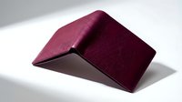 Burgundy leather bifold wallet on white background, showcasing premium texture and minimalist design for fashion and lifestyle concepts.