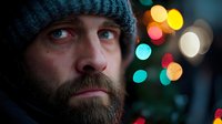 Bearded man in knit hat with colorful bokeh lights background creating warm atmospheric portrait for holiday seasonal marketing campaigns.