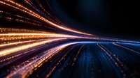 Dynamic light trails creating futuristic speed motion effect with glowing orange and blue streaks against dark background, abstract technology concept for digital transformation.