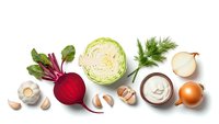 Fresh organic vegetables and ingredients arranged on white background including cabbage, beetroot, mushrooms, onion, garlic, dill and sour cream for cooking.