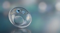 Empty clear glass bowl on reflective surface with soft bokeh background lighting for kitchen dining and tableware concepts.
