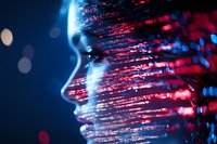 Female profile silhouette with glowing red and blue light trails creating futuristic digital transformation effect against dark background.