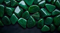 Polished malachite stones on dark background showcase rich emerald green color and natural mineral patterns, suitable for wellness and crystal healing designs.